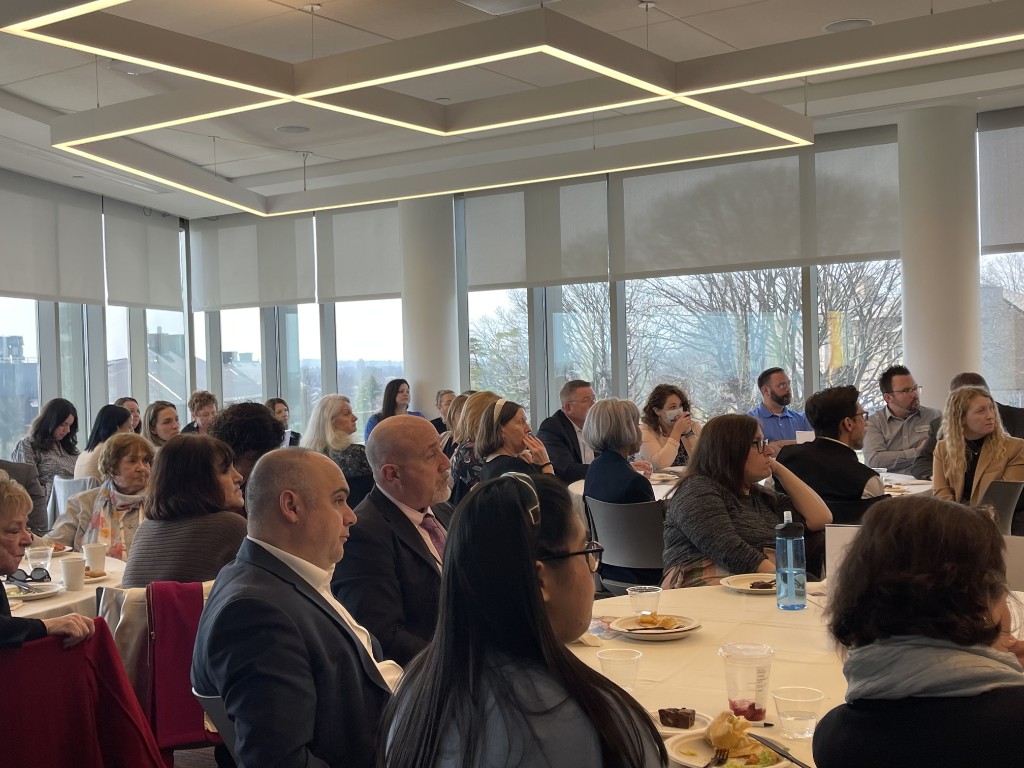 Professional meeting with attendees at round tables during a community gathering
