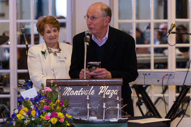 Judy Lonergan and Roland Pauthier at a Chamber event; Roland speaks at the podium with Judy beside him