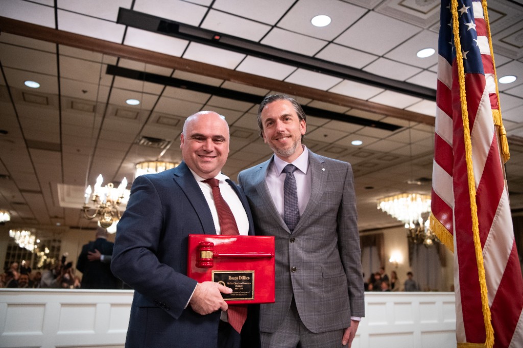 Outgoing president Rocco DiRico receives a recognition plaque with a ceremonial gavel at the installation and award ceremony.