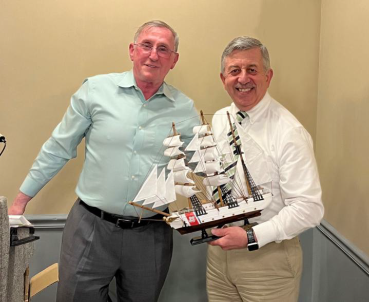 Two Chamber representatives with a model sailing ship award at an installation ceremony.